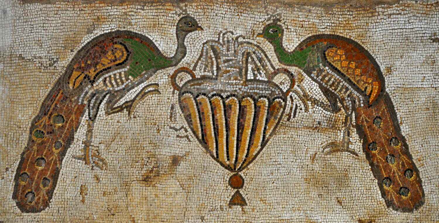 Mosaic artwork featuring two peacocks and a vase on a textured background